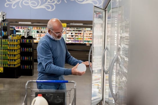 Person in grocery store looking at food packaging