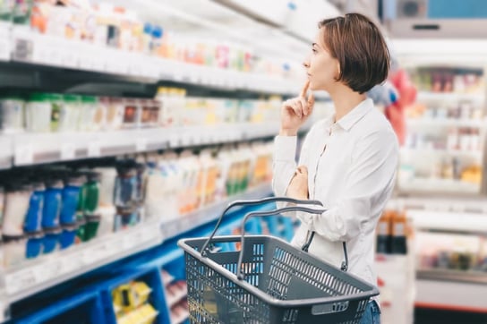 Person in grocery store looking at wellness items on shelf