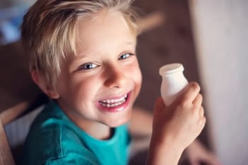 child with drinkable yogurt