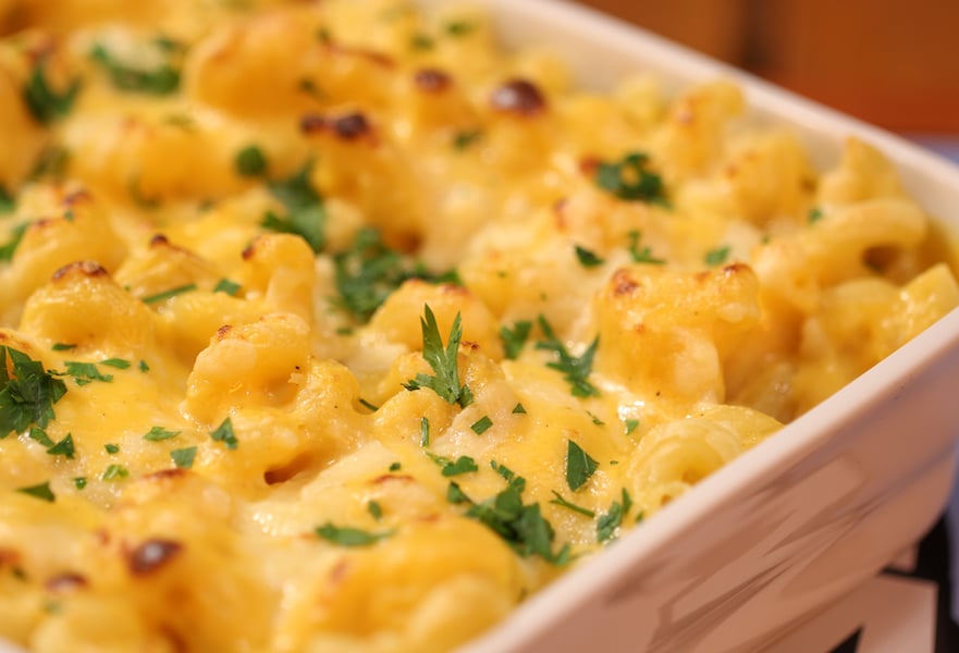 Mac and cheese in a casserole dish sprinkled with parsley