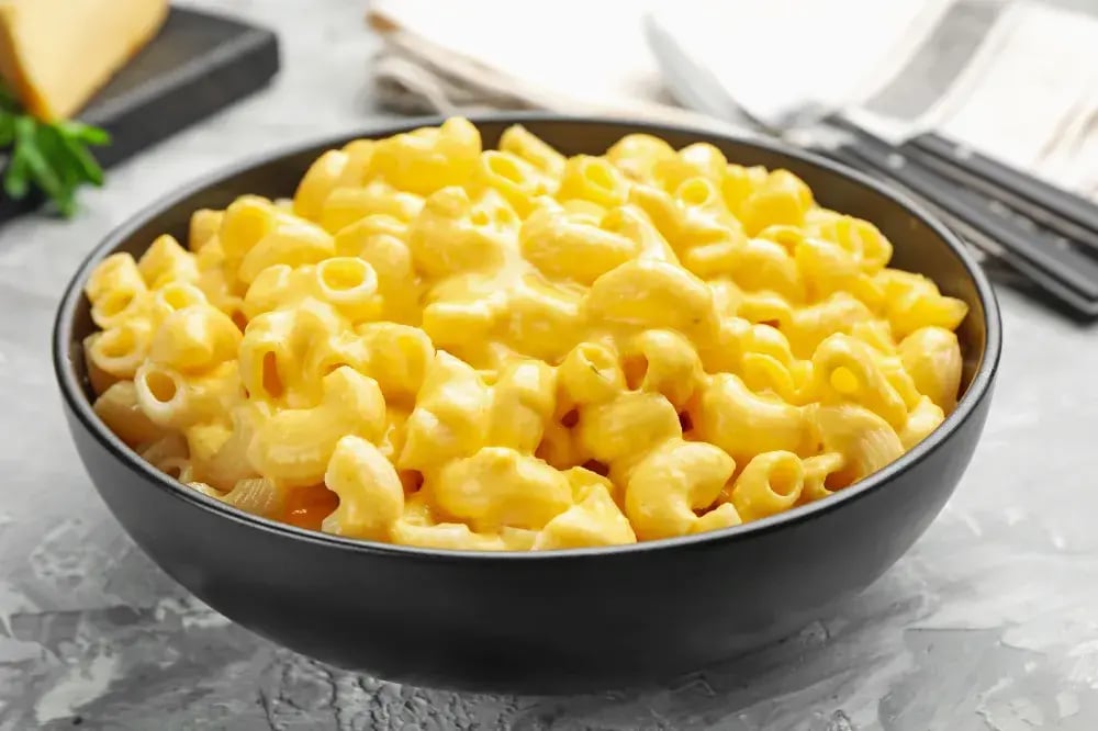 Picutre of cheesy mac and cheese for an article exploring the food science behind why reduced-sodium and reduced-fat cheese sauces often fail sensory testing and the formulation strategies used to rebuild the attributes consumers expect.